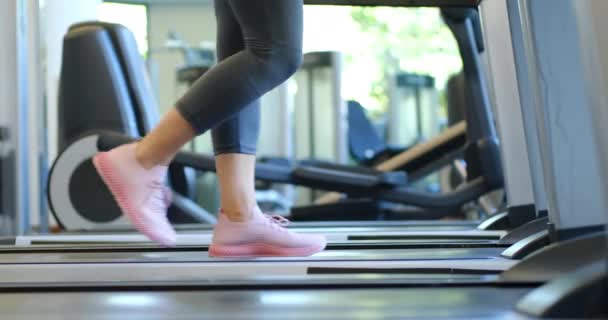 Pink trainers running on a treadmill